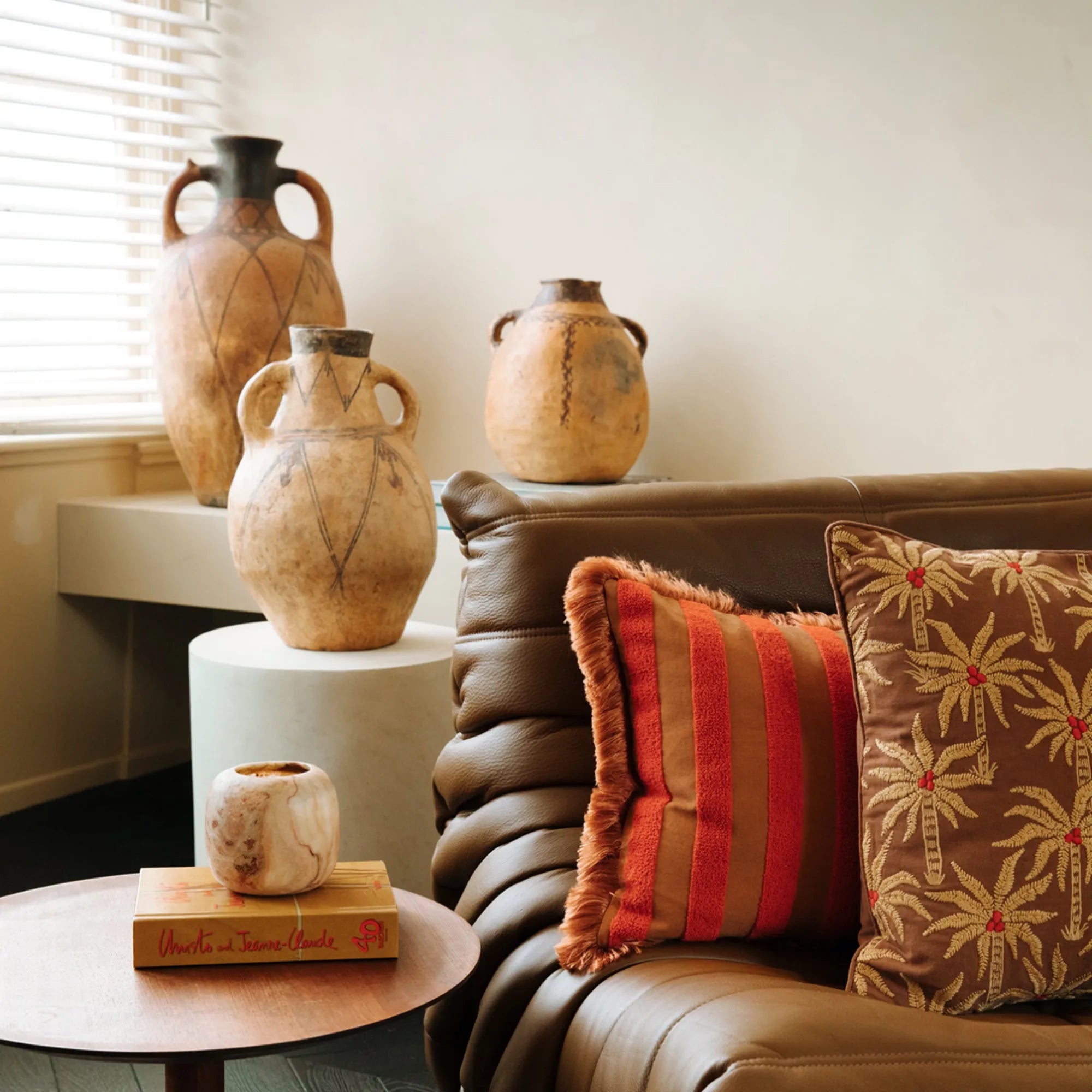  Laura Cushion shown in a cozy living room setting with natural light