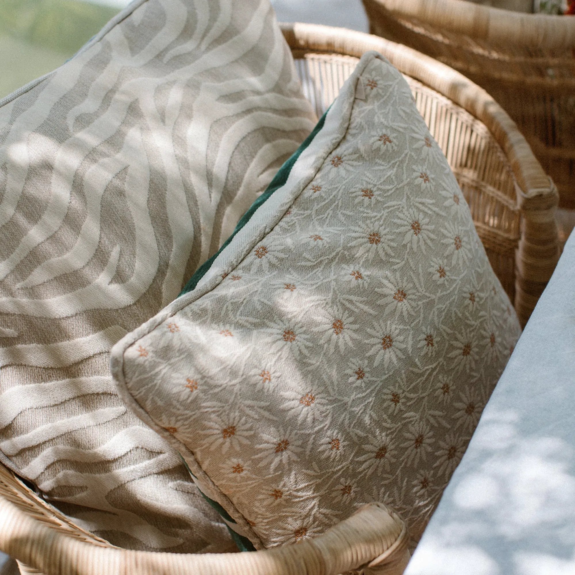  Amina Cushion with Frills placed on a lounge chair, offering comfort and style in any space 