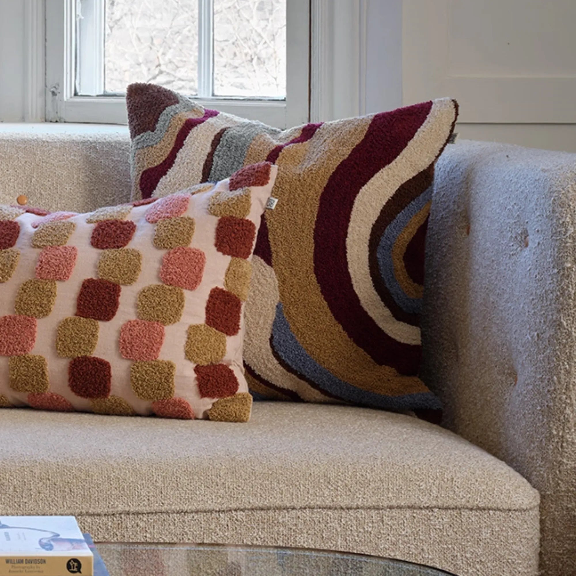 Close-up of Sagar Boucle Cushion Pillow in Dusty Blue and Ruby, showcasing its intricate texture and vibrant colors