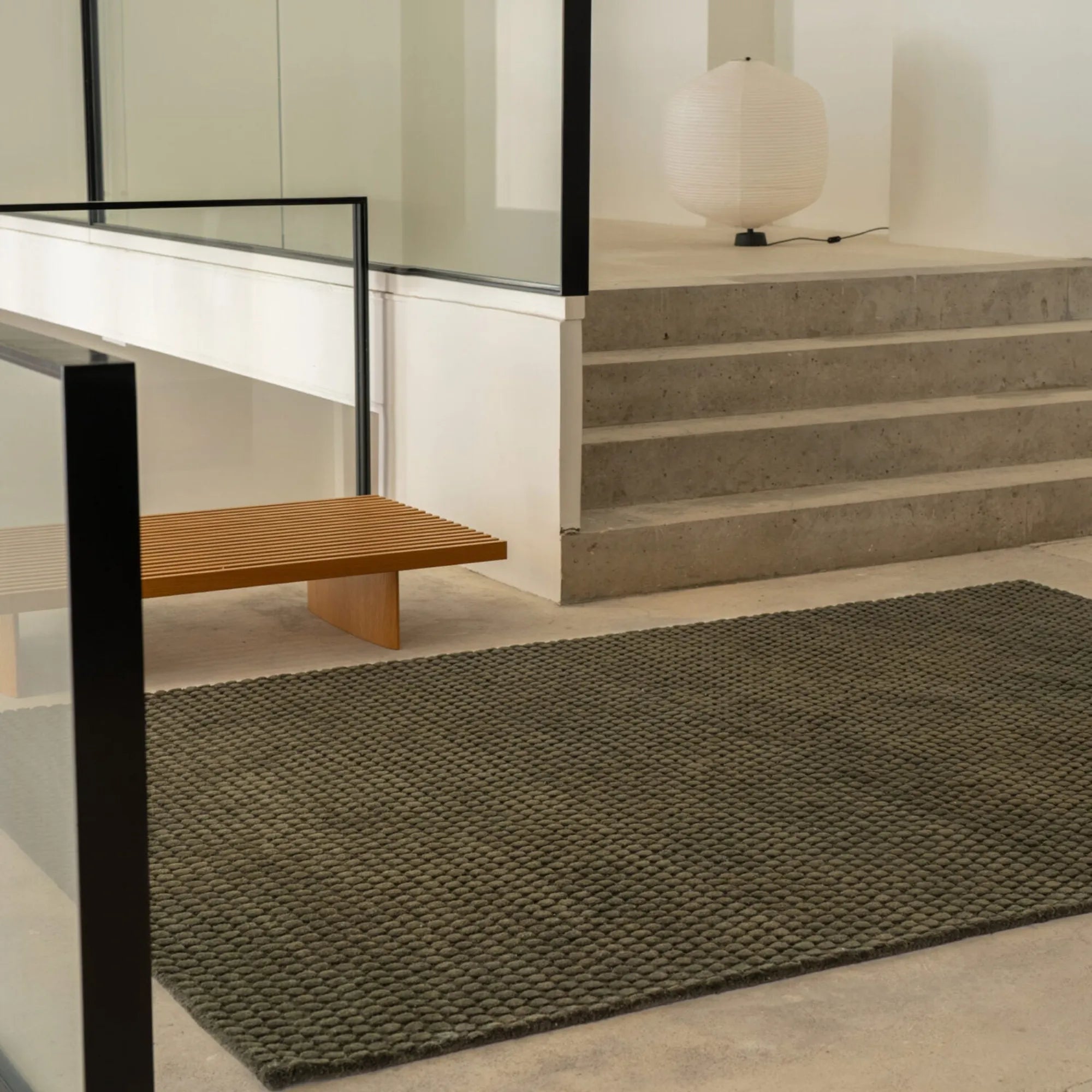 A luxurious, handwoven surface rug with a modern geometric pattern